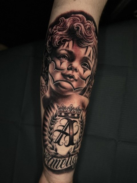 Cherub & crown monogram tattoo, forearm · fresh