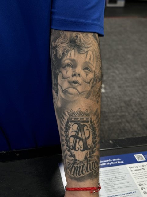 Cherub & crown monogram tattoo, forearm · healed