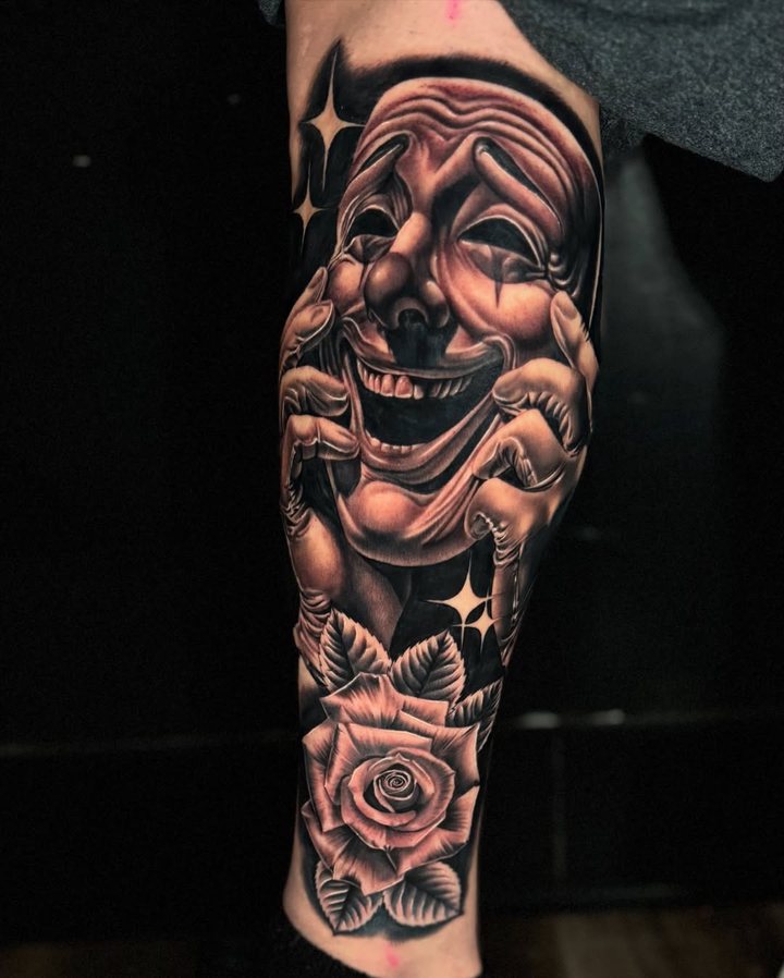 Laughing mask & rose tattoo, calf · fresh