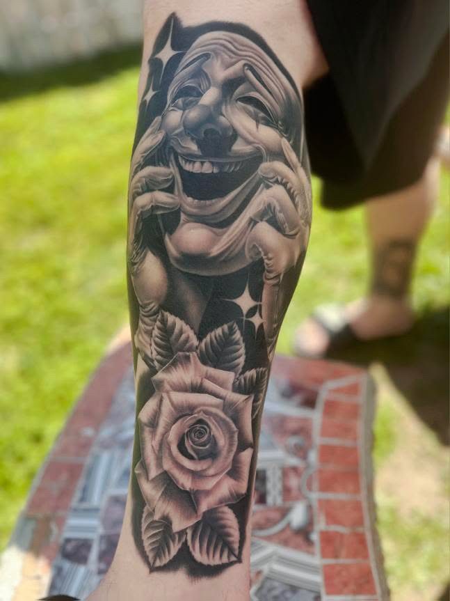 Laughing mask & rose tattoo, calf · healed
