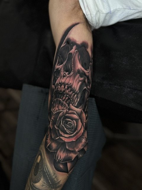 Skull & rose tattoo, upper arm · fresh